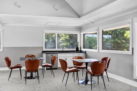 a dining room with a table and chairs
