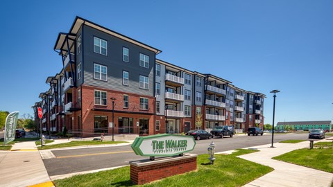 The Walker apartments are located in a sunny, urban area.