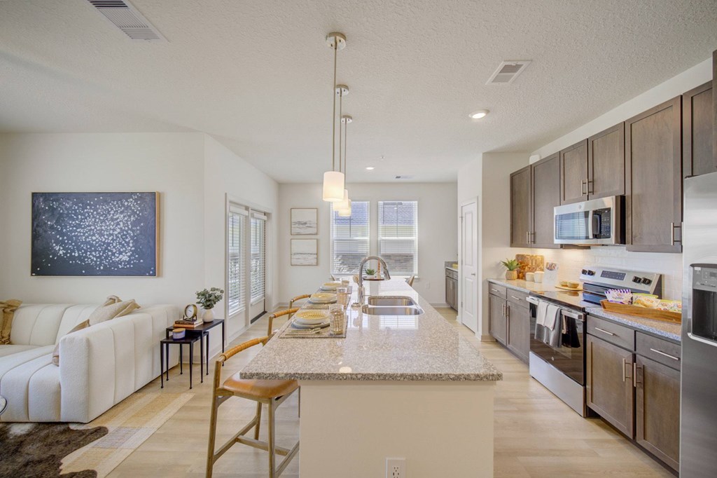 A modern kitchen with a long island in the middle.