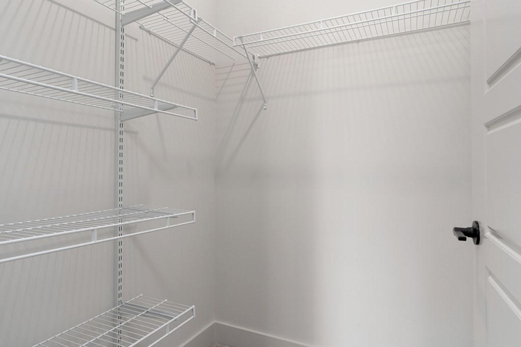 Empty white shelves in a room.