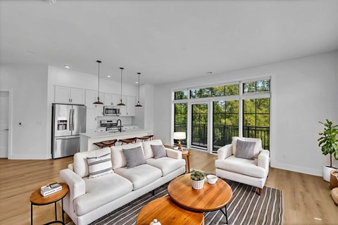 A modern living room with a white couch and a coffee table.