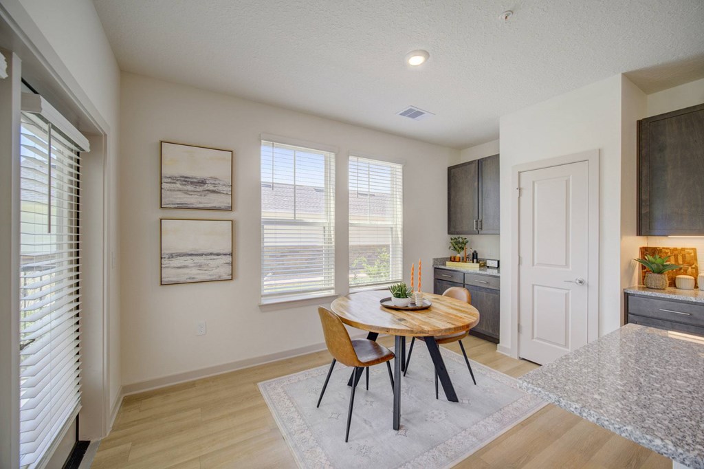 A dining room with a wooden table and chairs.