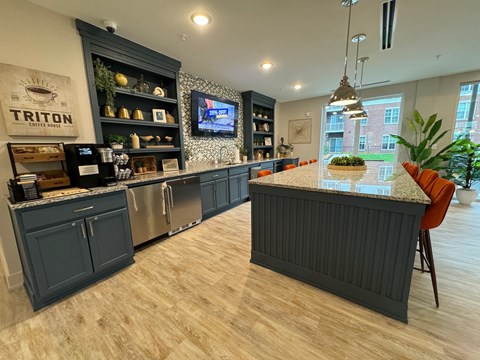 A modern kitchen with dark wood cabinets and a marble countertop.