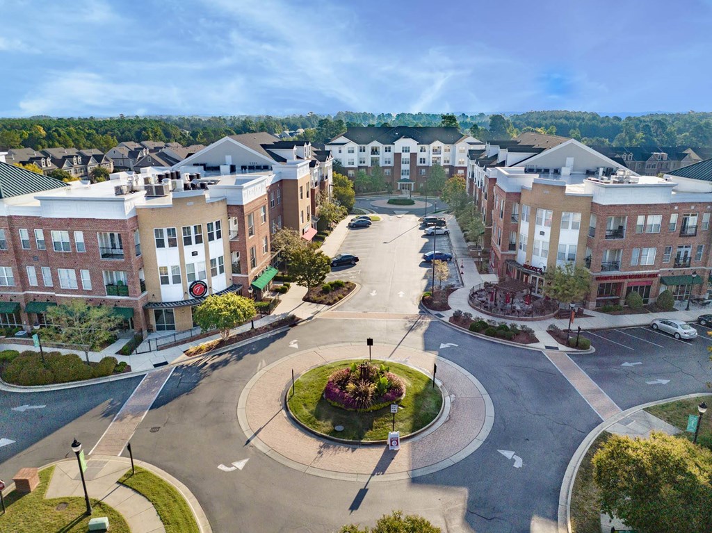 an aerial view of a city street with buildings and a fountain
