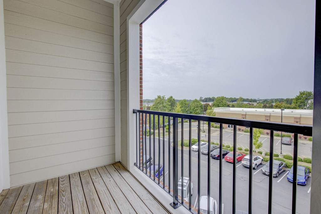 a balcony with a view of a parking lot
