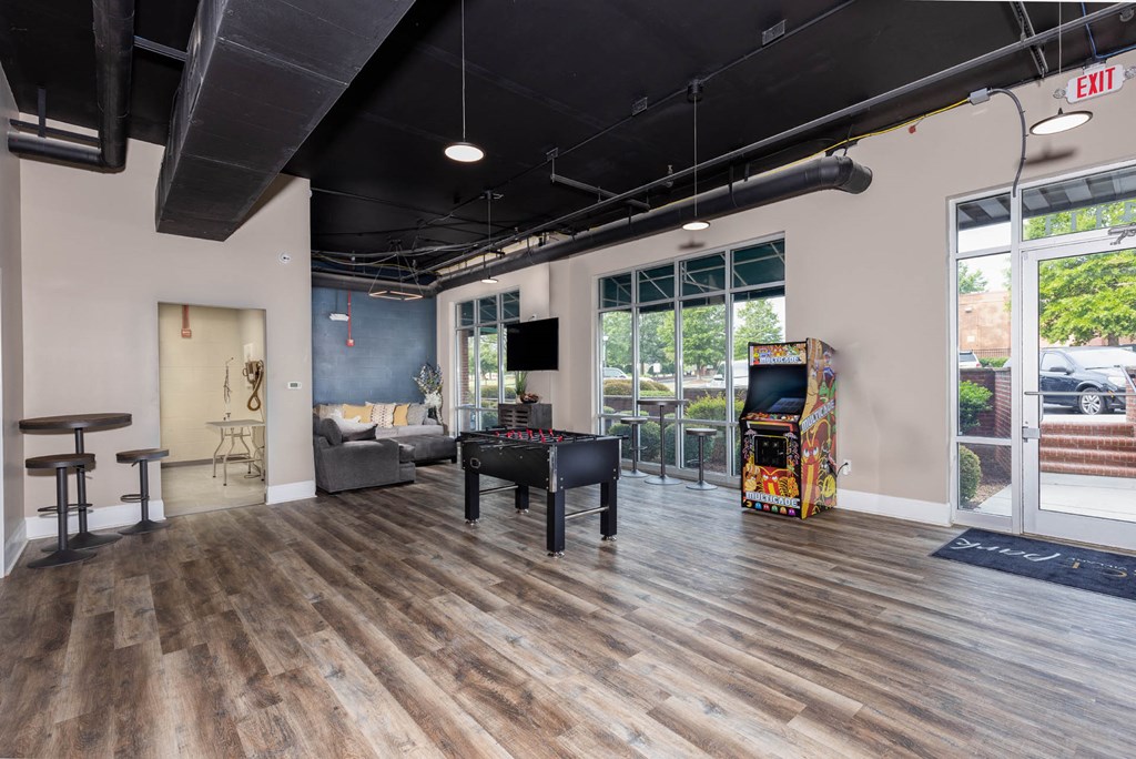 a living room with a pool table and a video game