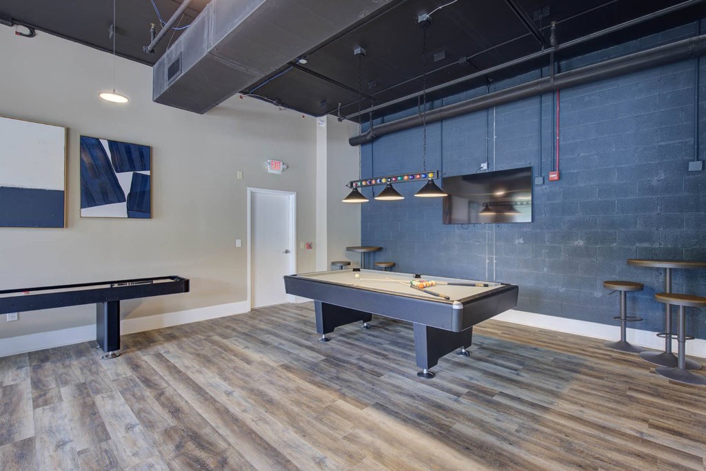 a game room with a pool table and ping pong
