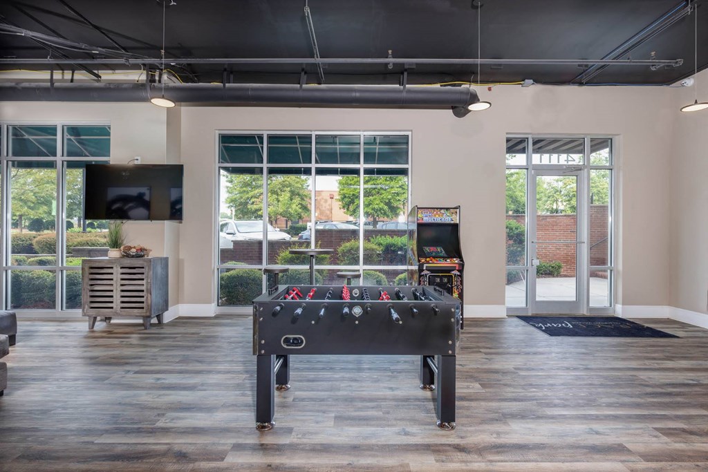 a game room with a pool table and a tv