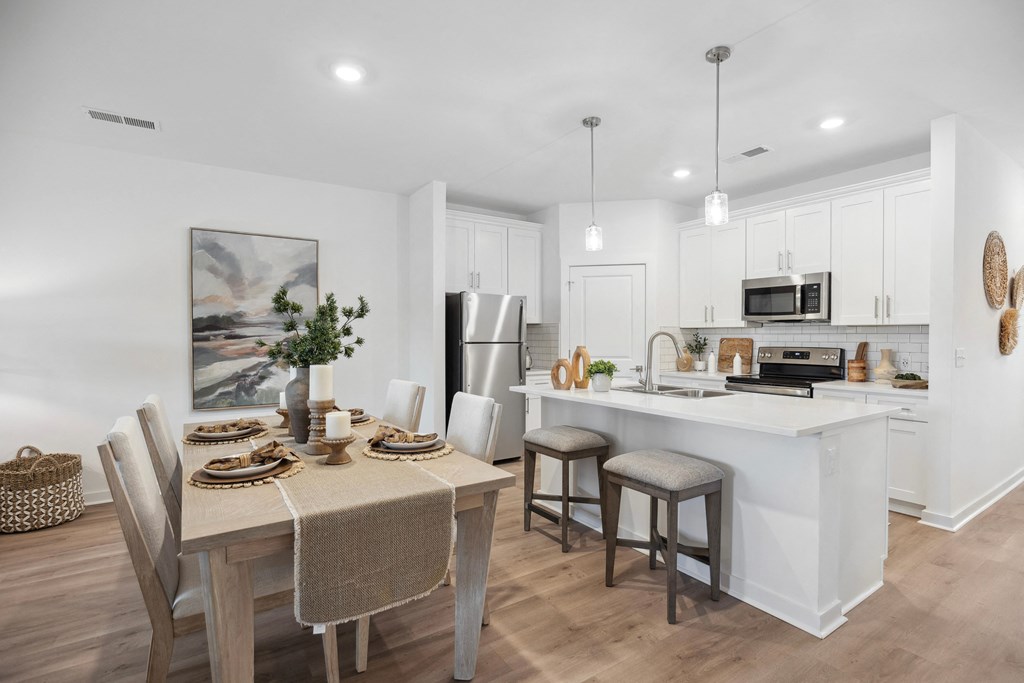 an open kitchen and dining area with a table and chairs