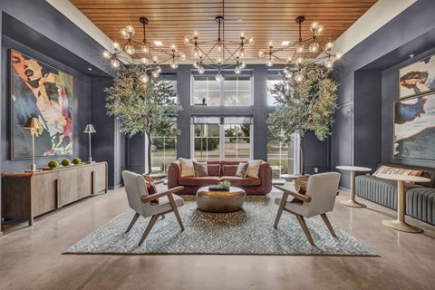 A modern living room with a large window, a sofa set, and a coffee table.