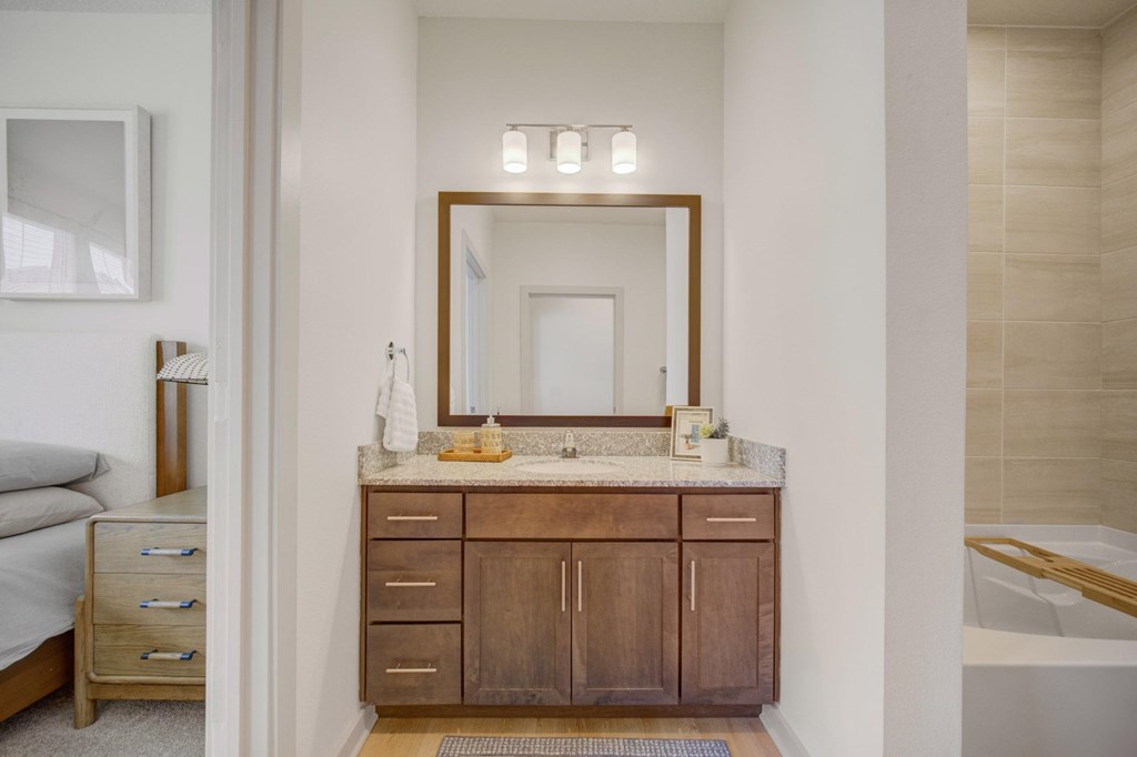 A bathroom with a vanity and a mirror.