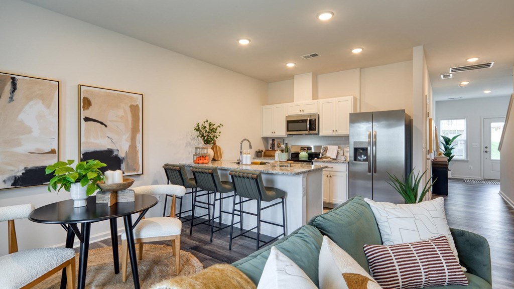 A modern kitchen with a dining table and chairs at The Mark Townhomes Apartments, Virginia, 22801