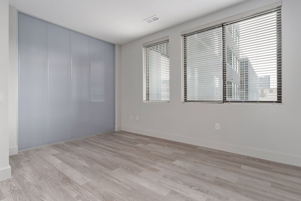 A room with a window and a sliding door.