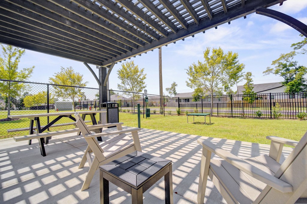 A park with a canopy and benches.