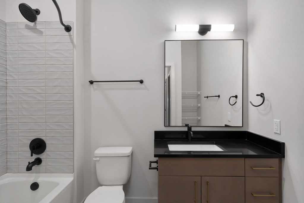 A white toilet sits next to a sink in a bathroom.