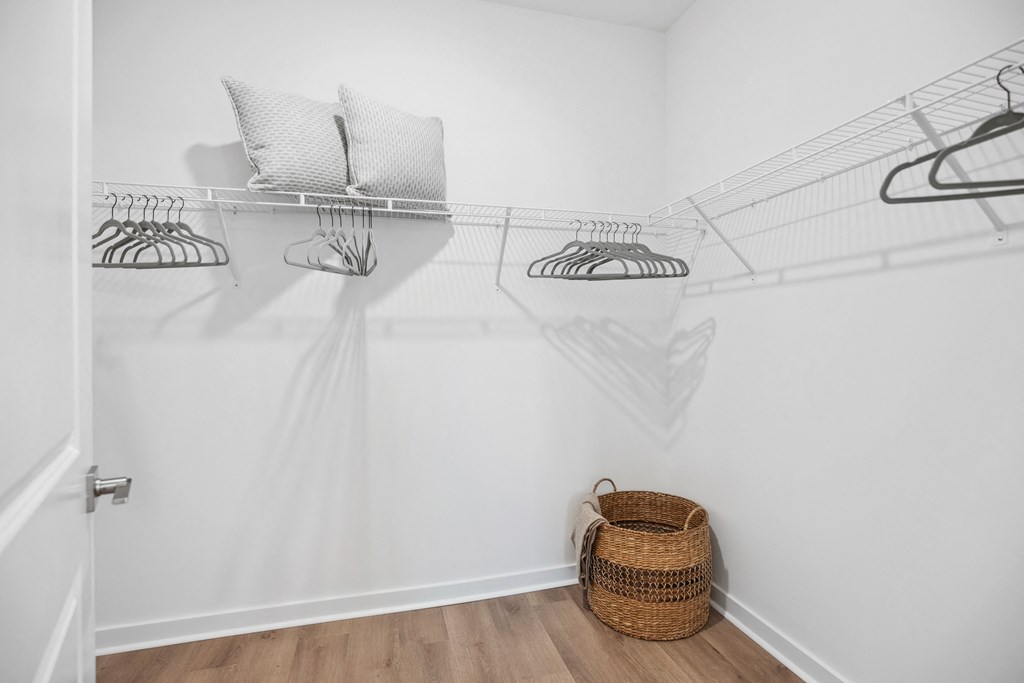 a laundry room with white walls and a basket on the floor