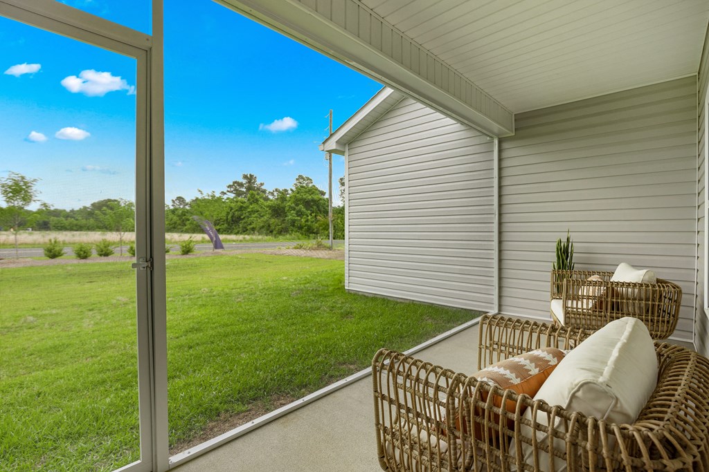 a patio with two chairs and a sliding glass door