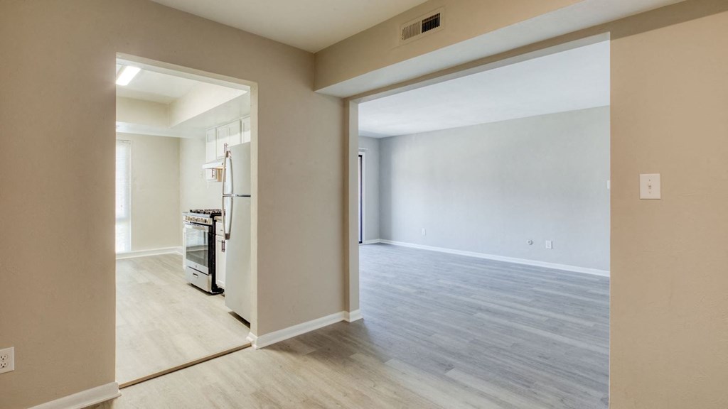 an empty living room and kitchen with a door open to the dining room at Bayville Apartments, Virginia Beach, 23455