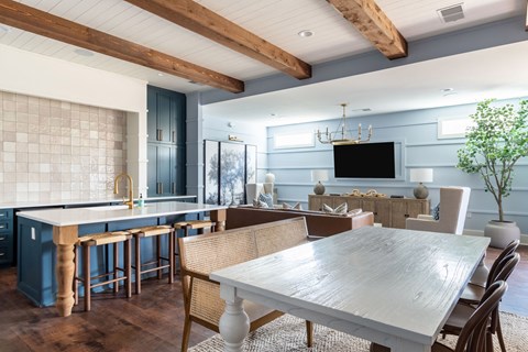 A modern kitchen with a dining table and chairs.