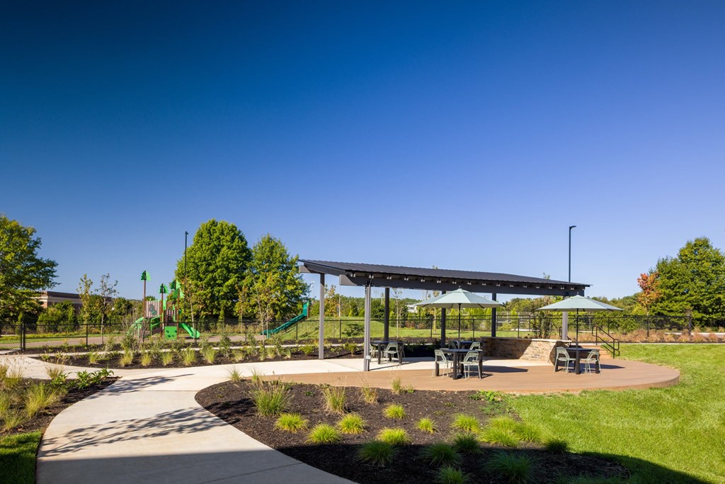 A playground with a slide and a canopy.