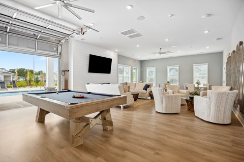a living room with a pool table and a tv