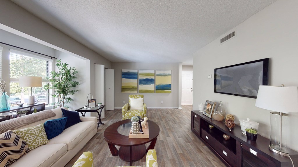 a living room with a couch coffee table and a tv