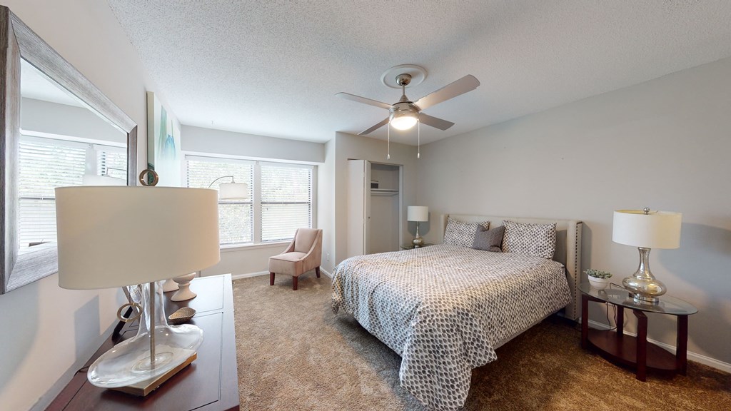 a bedroom with a bed and a ceiling fan