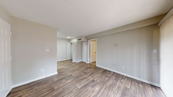 a living room with hardwood floors and grey walls