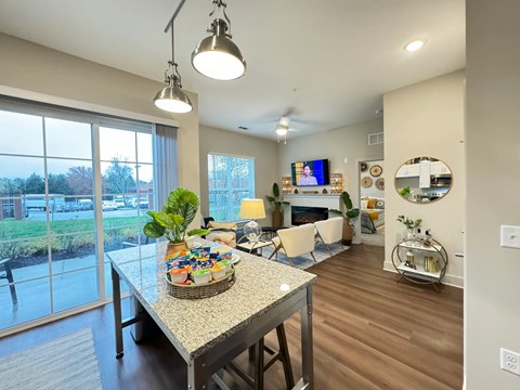 A modern living room with a dining table and chairs.