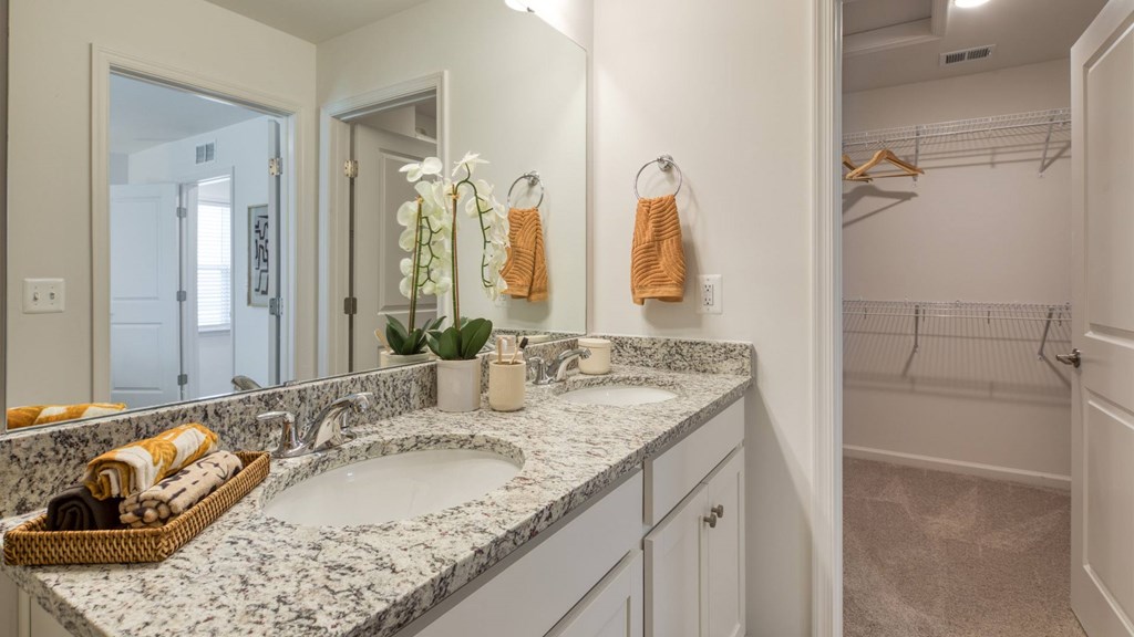A bathroom with a marble countertop and double sinks at The Mark Townhomes Apartments, Harrisonburg, VA, 22801