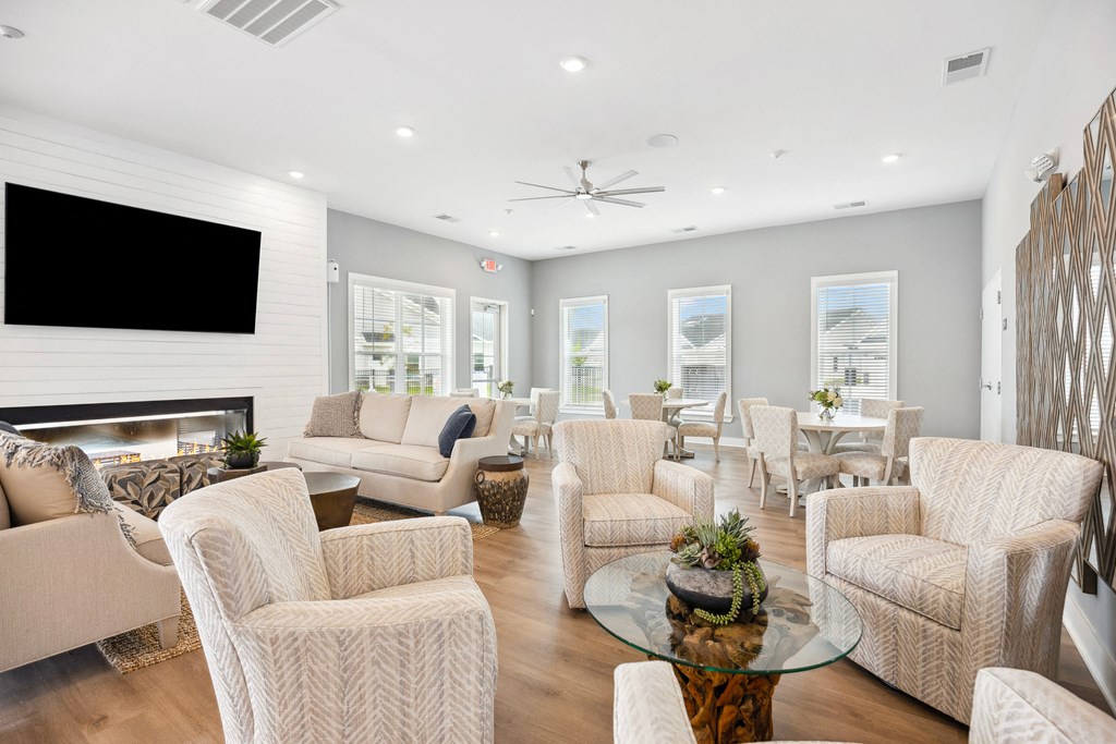 a living room with white couches and chairs
