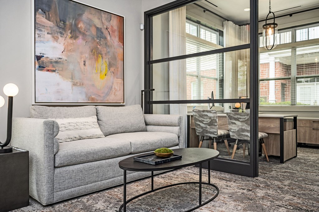 A grey couch with a coffee table in front of it.
