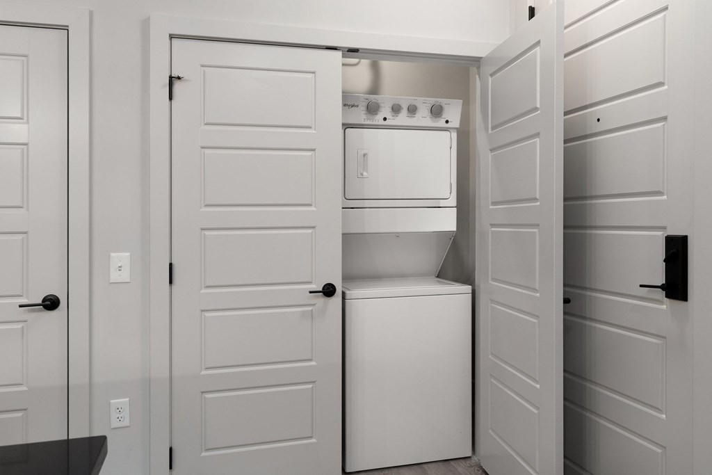 A white kitchen with a dishwasher and oven.