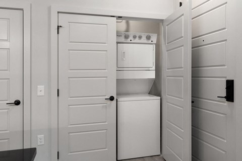 A white kitchen with a dishwasher and oven.