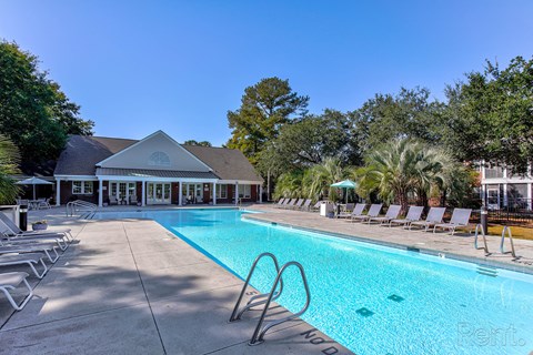 a swimming pool with chairs and a building in the backgroundat Barclay Place Apartments, Wilmington