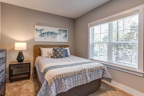 a bedroom with a bed and a large window at Barclay Place Apartments, North Carolina