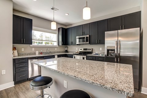 A kitchen with granite countertops and stainless steel appliances.