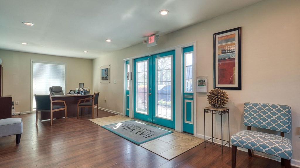 a living room with turquoise doors and a table with chairs at Bayville Apartments, Virginia Beach, Virginia