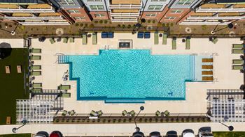 An aerial view of a swimming pool surrounded by a fence.