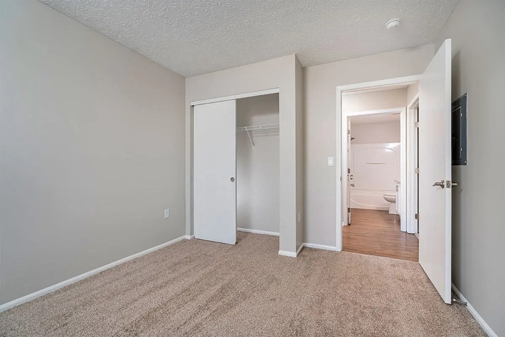 A room with carpeted floor and white walls.