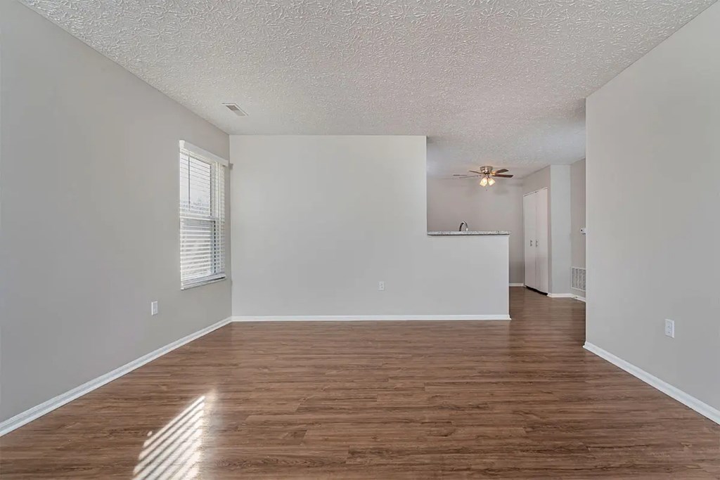 A room with wooden floors and white walls.