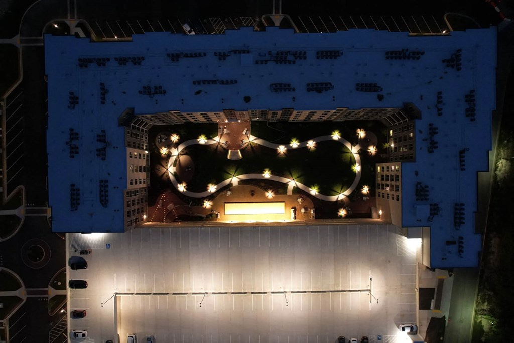 an overhead view of a building at night with lights on itat Metropolis Apartments, Glen Allen Virginia