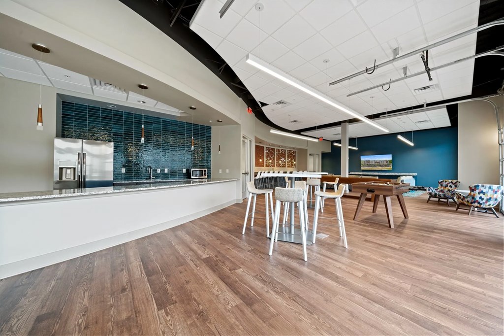 a large room with tables and chairs and a bar at Metropolis Apartments, Glen Allen, VA 23060