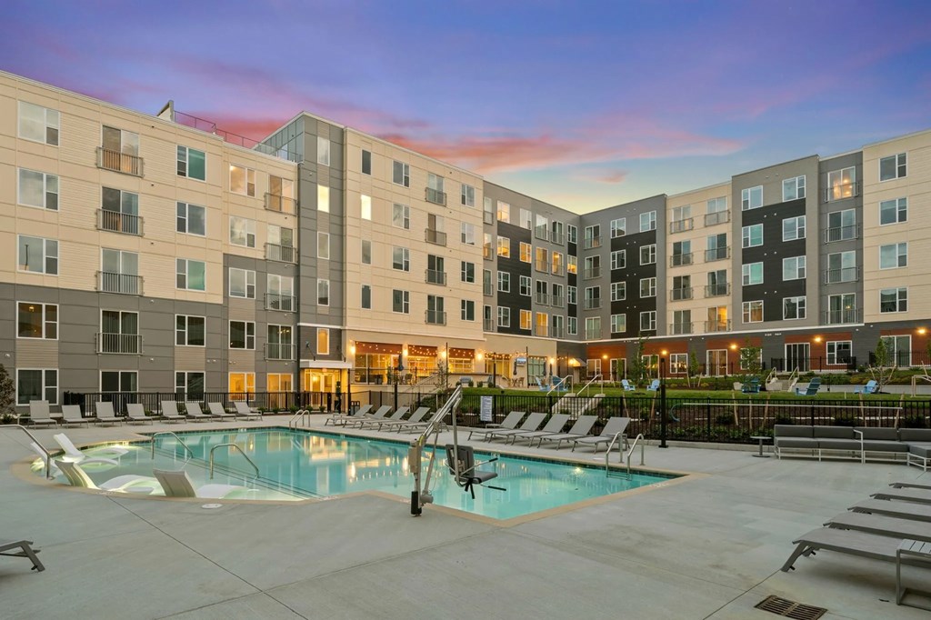 an apartment building with a swimming pool at duskat Metropolis Apartments, Virginia, 23060