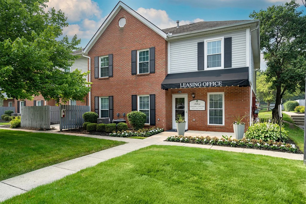 A brick house with a sign that says