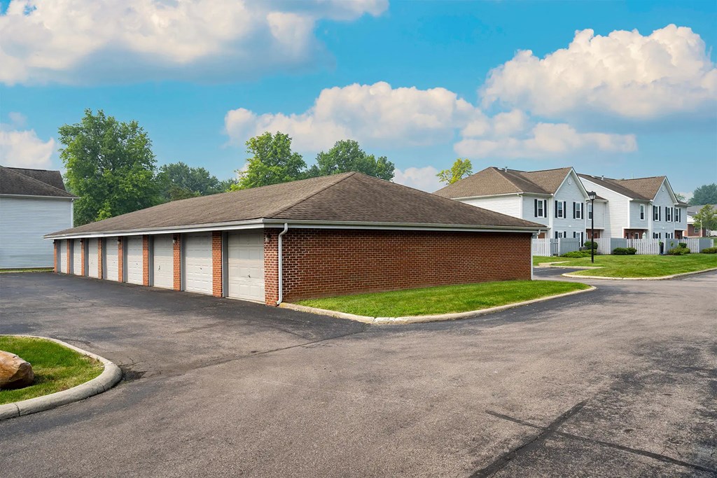 A large brick building with a parking lot in front.