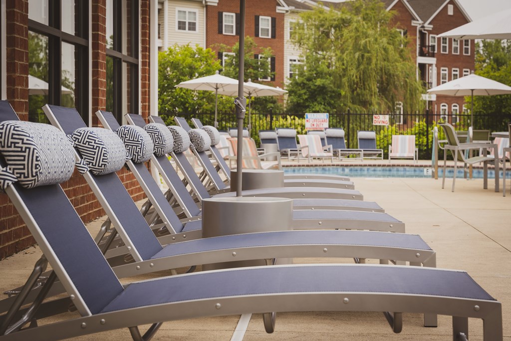 A row of sun loungers are lined up by a pool.at Arlington Park, Hilliard, OH 43026