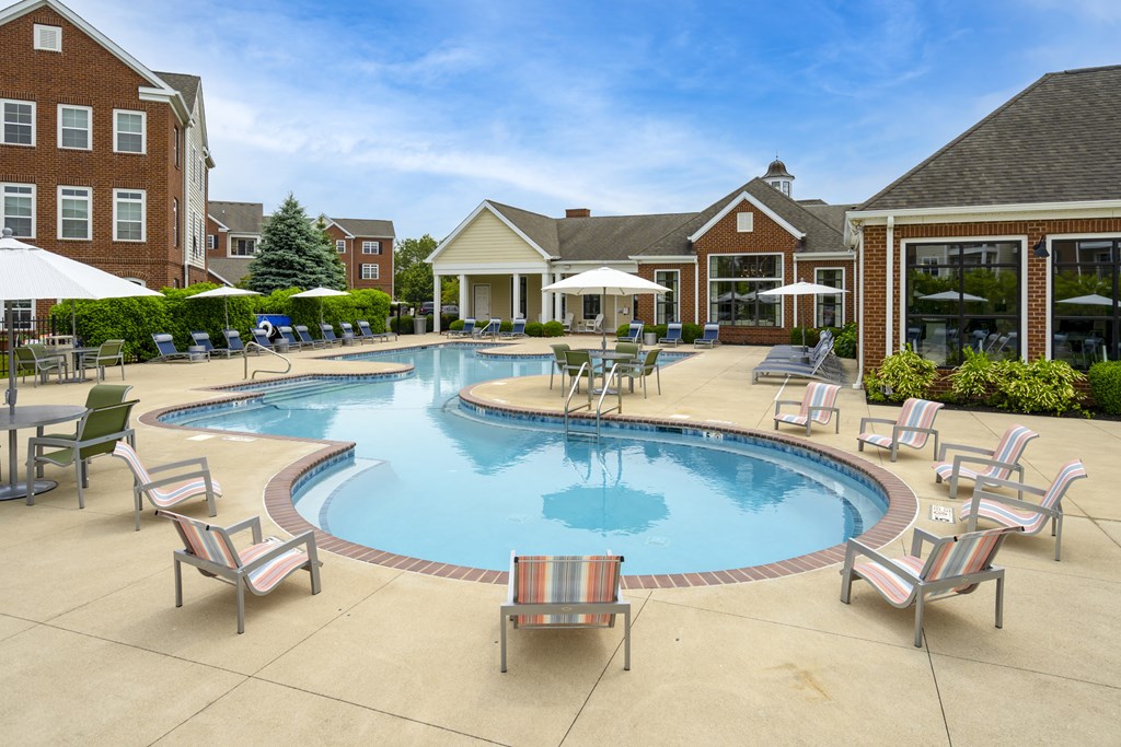 A large outdoor swimming pool surrounded by lounge chairs.at Arlington Park, Hilliard Ohio