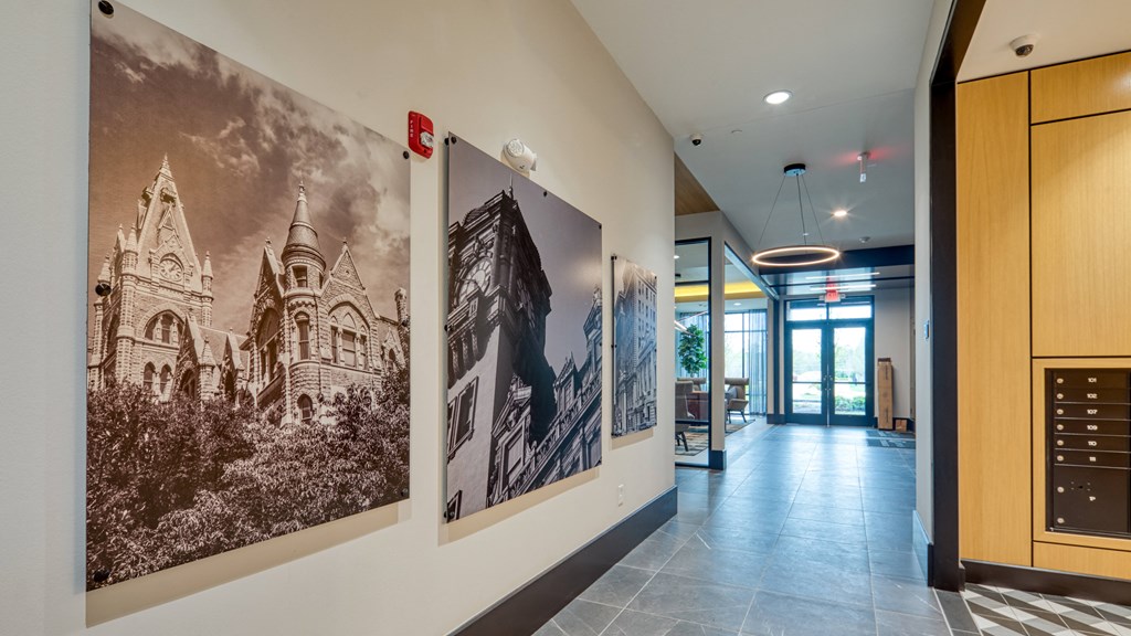 a hallway with large pictures on the wall and a lobby door at Aura Stonebridge, Richmond