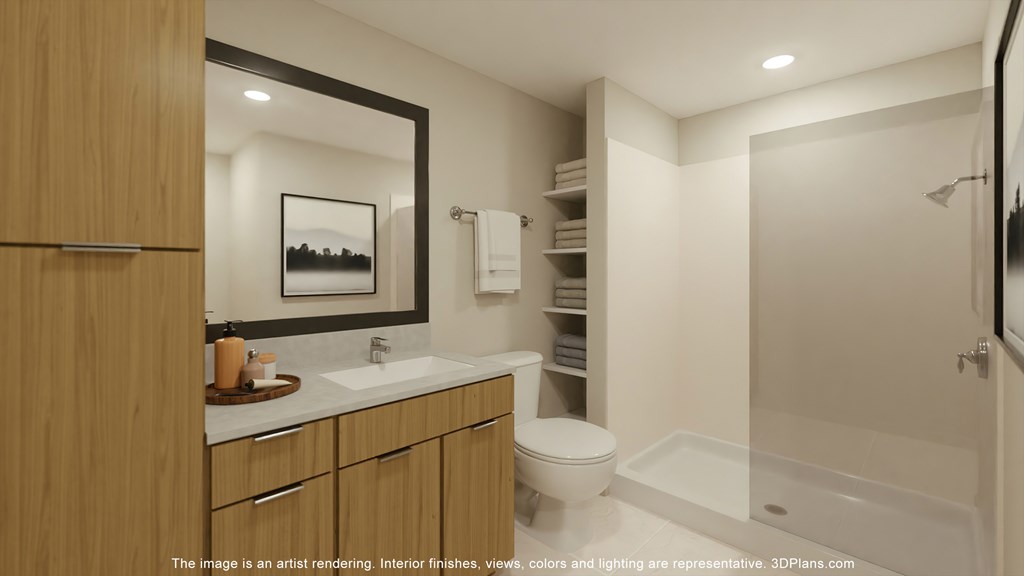 A modern bathroom with a wooden vanity and white fixtures.